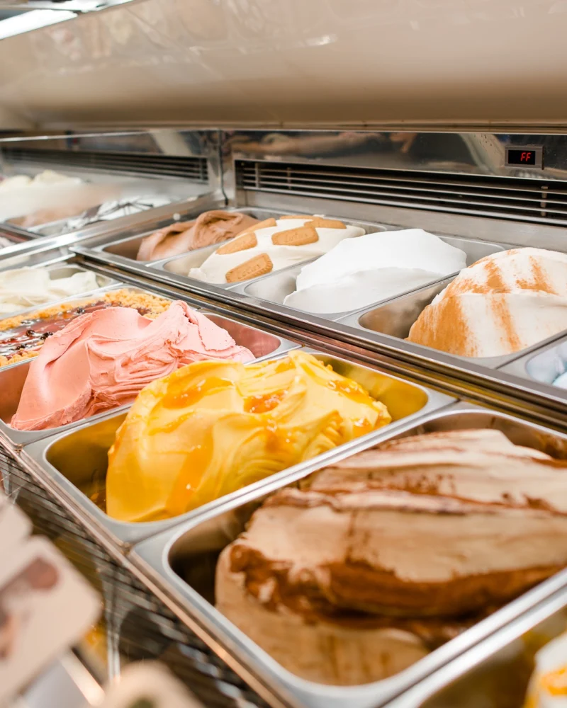 Ice cream display with cream ice cream and sorbet in stainless steel tubs